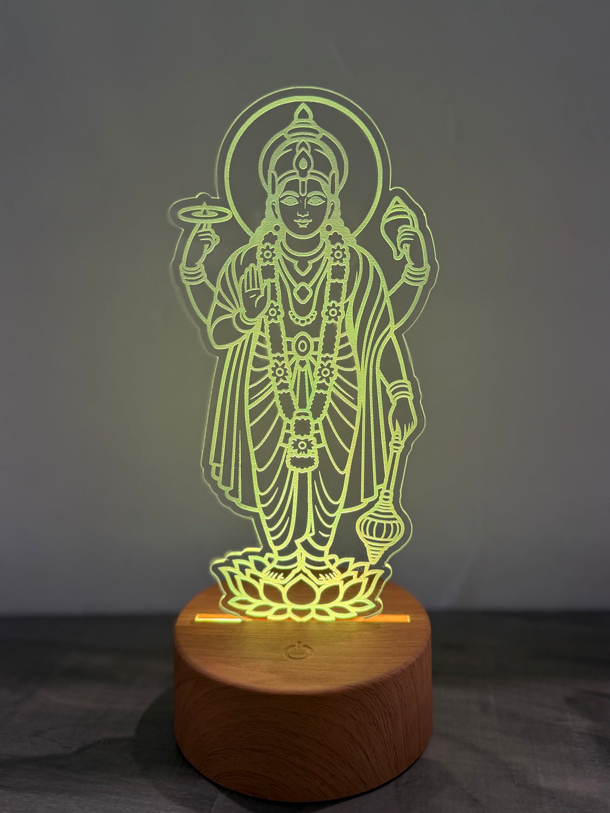 Satyanarayana 3D lamp glowing yellow-green showing wooden LED base with touch button