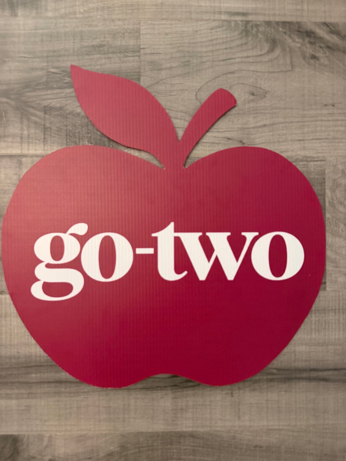 Custom shape coroplast sign cut as a red apple with a business logo - custom cutout sign by RA Kreations