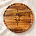 Round 12-inch wooden pooja tray with laser-engraved Om symbol – natural wood grain by RA Kreations