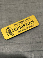 Yellow engraved name badge with pineapple logo: Christian, Cabana Service