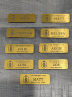 Set of yellow engraved club name badges with pineapple logo and service roles