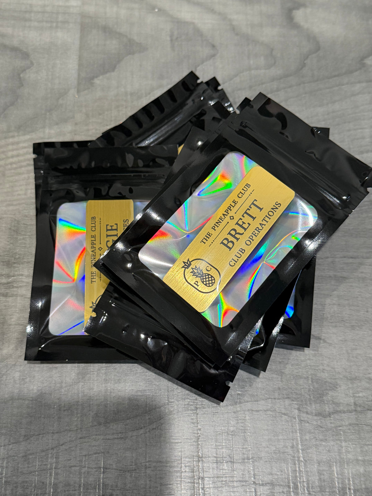 Holographic custom name badge set with logo cards in black sleeves
