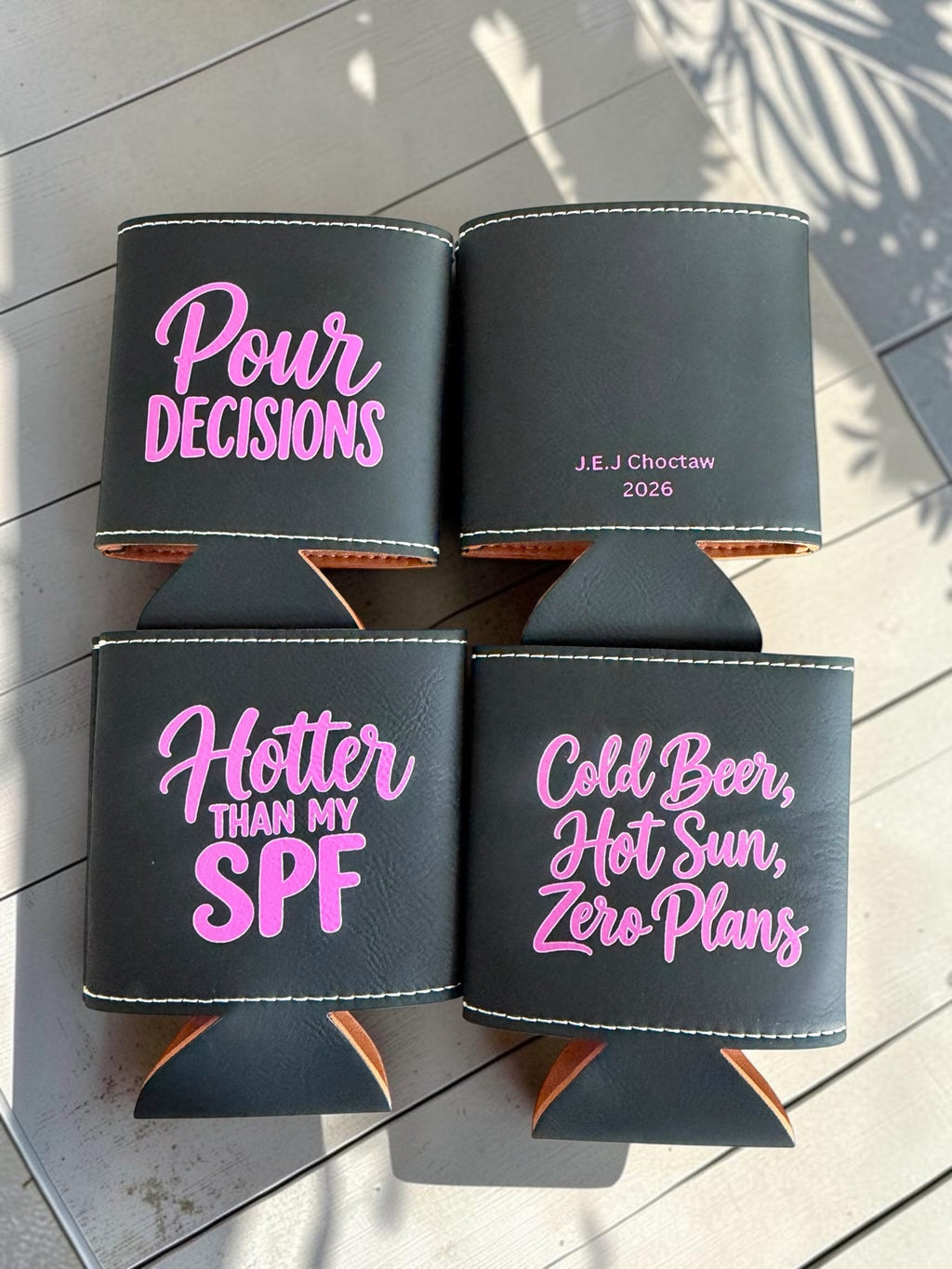 Black leatherette can coolers with pink engraved text, front and back personalization
