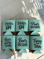 Custom leatherette can coolers in mint teal with funny beer sayings engraved in black