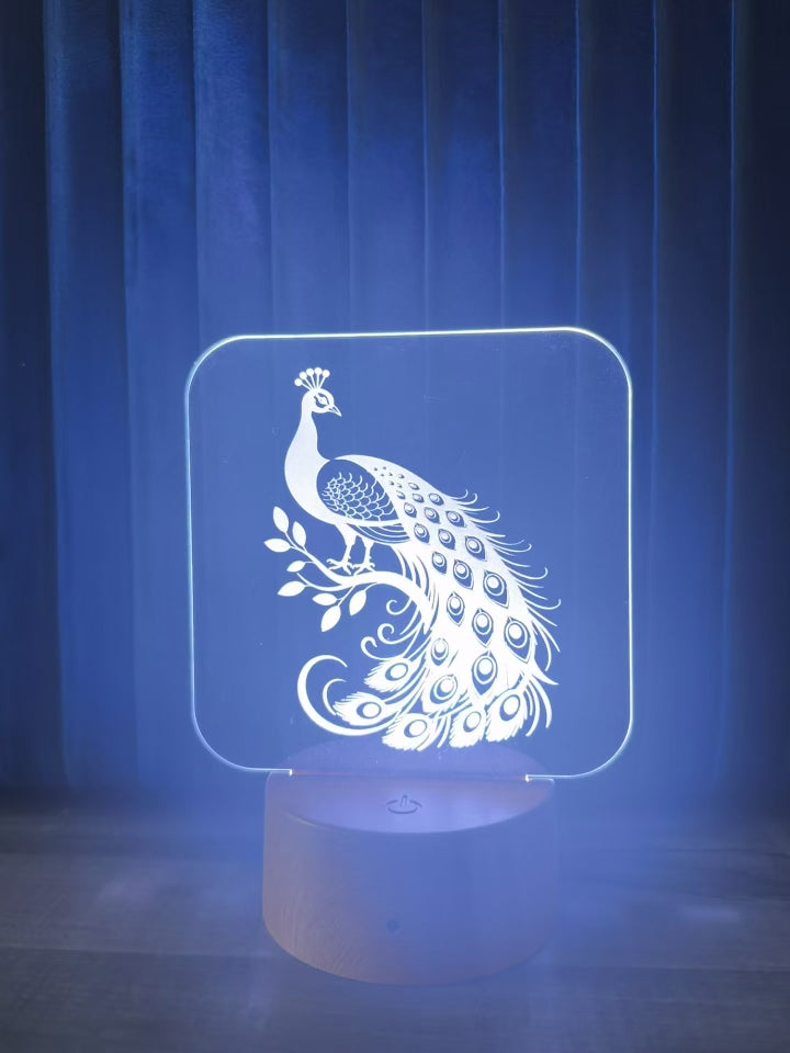 Video of peacock acrylic LED lamp cycling through colors on wooden base