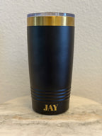Personalized black 20oz insulated tumbler laser engraved with custom name JAY in gold