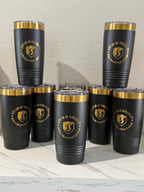 Bulk order of custom black 20oz laser-engraved tumblers with gold business logos for corporate gifts